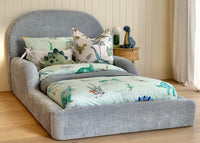 Blue kids bed side view dresses in dinosaur themed linen