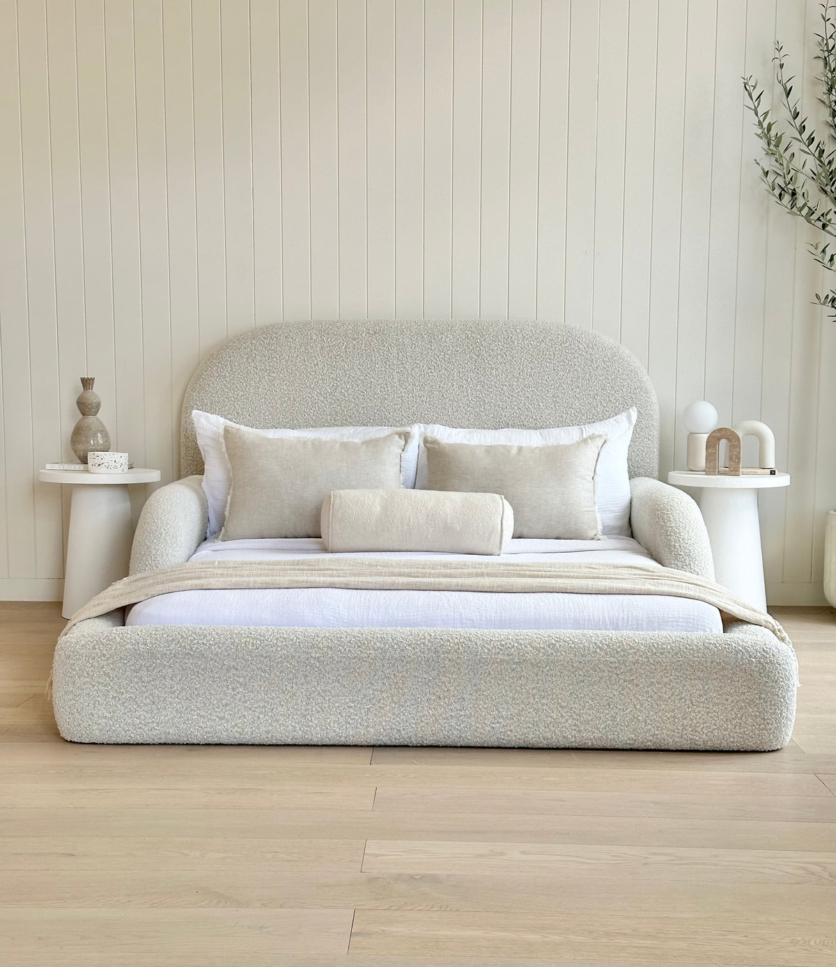 Front view of the boucle upholstered Tulum Kids Bed styled with neutral bedding