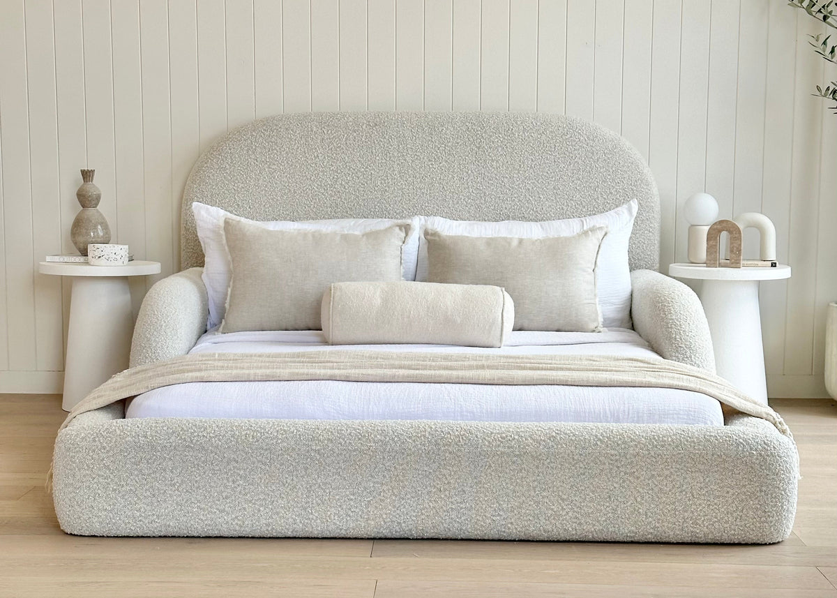 Front view of the boucle upholstered Tulum Kids Bed styled with neutral bedding