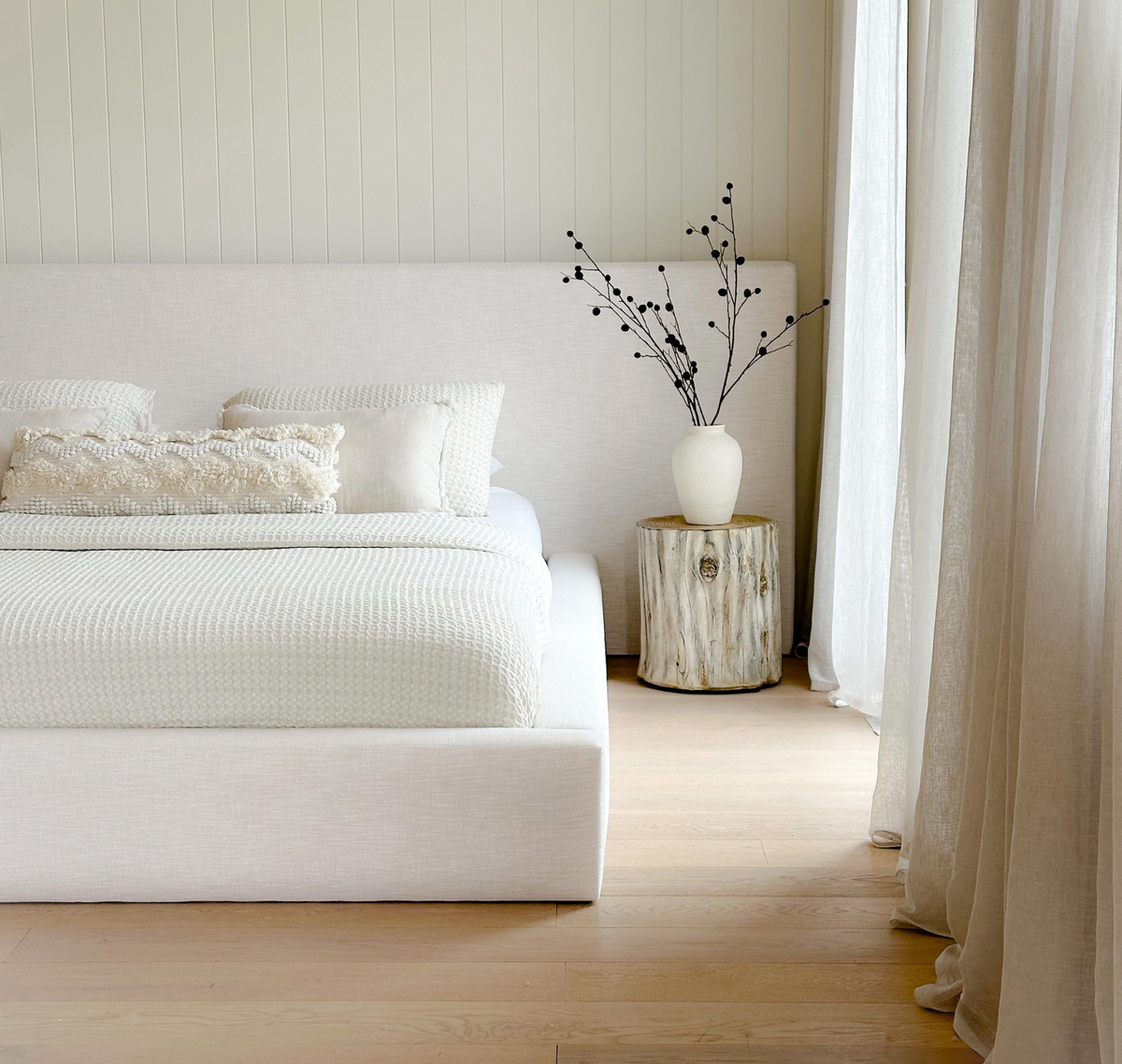 Elouda Bed styled in a light-filled room with neutral décor and natural timber flooring