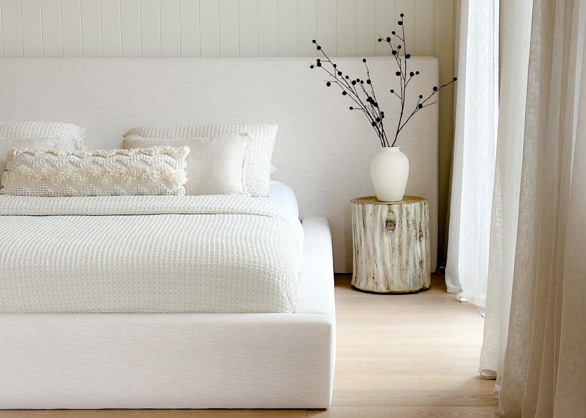 Elouda Bed styled in a light-filled room with neutral décor and natural timber flooring