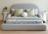 Front view of the grey/blue Tulum Kids Bed styled with dinasour themed bedding
