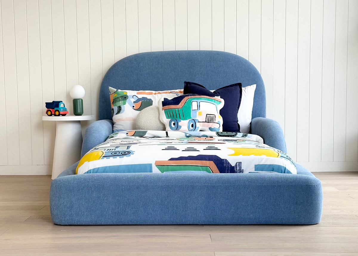 Tulum Kids Bed in soft blue upholstery with rounded padded frame by Kamari
