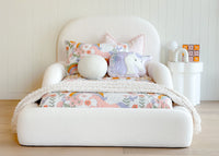 Tulum Kids Bed in white upholstery with rounded, cushioned frame by Kamari Furniture