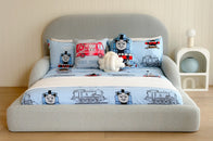 Children's bed with Thomas the Tank Engine bedding set in a room with wooden flooring and a white wall.
