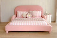 Pink bed dressed with stripes 