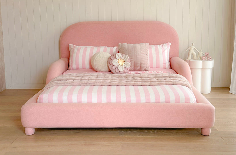 Pink bed dressed with stripes 