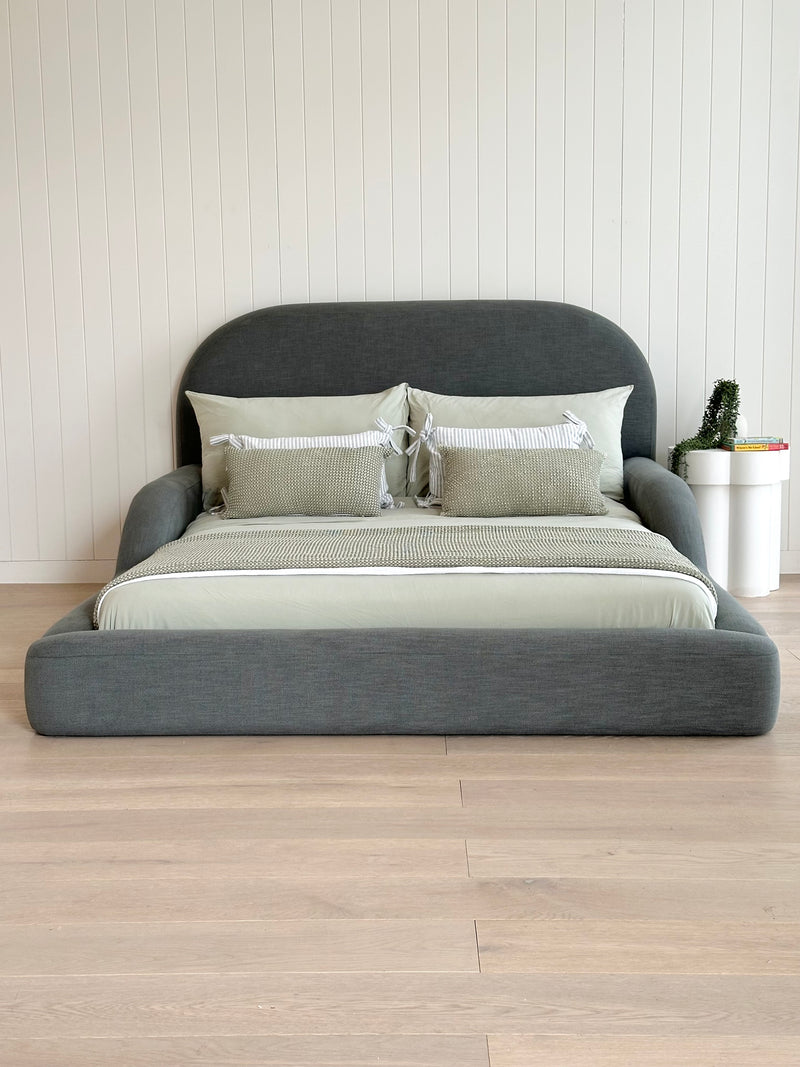 Tulum Kids Bed in dark green upholstery with rounded, cushioned frame by Kamari Furniture
