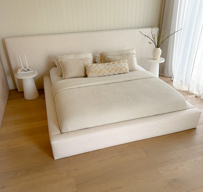 Modern luxury bed with soft-edged headboard and minimalist styling
