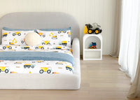 Children's bedroom with a bed featuring construction-themed bedding 