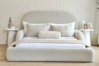 Front view of the boucle upholstered Tulum Kids Bed styled with neutral bedding