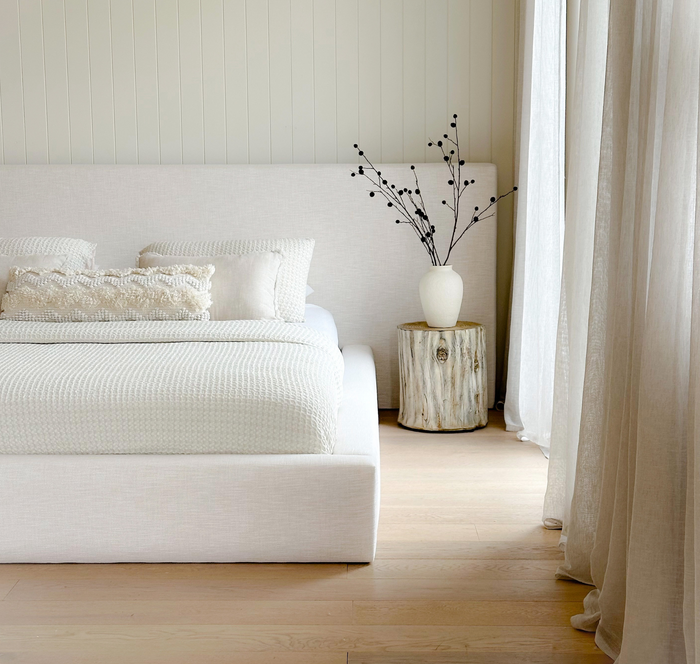 Elouda Bed styled in a light-filled room with neutral décor and natural timber flooring