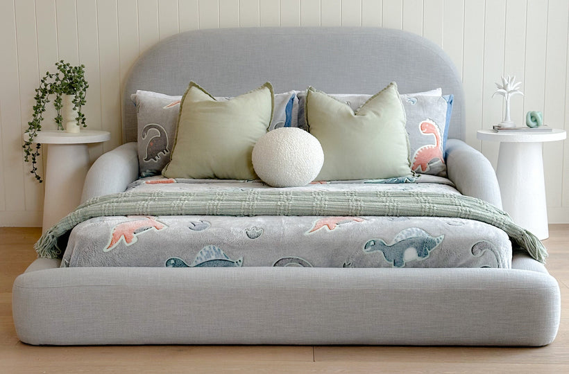 Front view of the grey/blue Tulum Kids Bed styled with dinasour themed bedding 