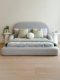 Front view of the grey/blue Tulum Kids Bed styled with dinasour themed bedding 
