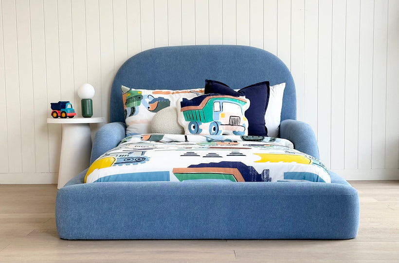 Tulum Kids Bed in soft blue upholstery with rounded padded frame by Kamari