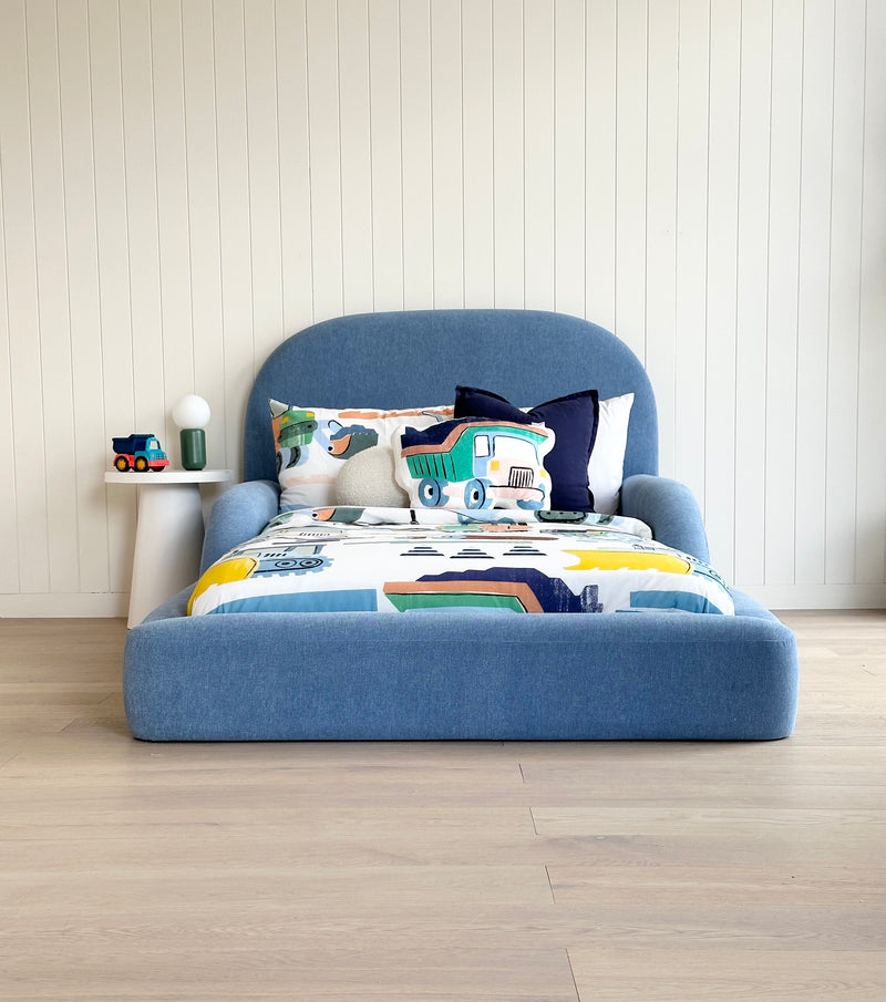 Tulum Kids Bed in soft blue upholstery with rounded padded frame by Kamari